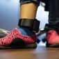 In this Monday, July 23, 2018, file photo, Immigrant seeking asylum Ildra Medreano wears an ankle monitor at a Catholic Charities facility not long after she was reunited with her son in San Antonio. Federal authorities' shift away from separating immigrant families crossing into the U.S. illegally now means that many parents and children are quickly released from custody only to be fitted with electronic monitoring devices, a practice that has spiked in recent years but which both the government and advocacy groups oppose for different reasons. (AP Photo/Eric Gay)