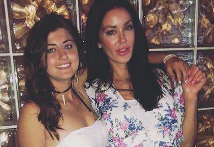 This undated photo provided by the Kraft family shows Kelsey Kraft, left, and her sister Christina Carlin-Kraft. Authorities say Christina Carlin-Kraft, a model found dead Wednesday, Aug. 22, 2018, in the bedroom of her apartment in Philadelphia's affluent Main Line suburb, was strangled. (Courtesy of the Kraft family via AP)