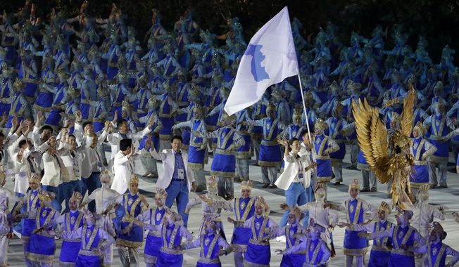 The combined Koreas march into Gelora Bung Karno Stadium under the &amp;quot;unification&amp;quot; flag during the opening ceremony for the 18th Asian Games in Jakarta, Indonesia, Saturday, Aug. 18, 2018. (AP Photo/Lee Jin-man)
