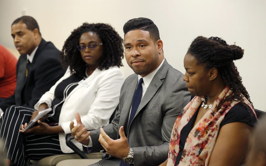 Devin Del Palacio, second from right, a Democrat running for the Arizona House of Representatives, speaks during an African-American candidates forum along with Democrat mayoral candidate Tim Seay, left, Justice of the Peace candidate Sharon Sauls, second from left, and Democrat candidate for Arizona Corporation Commission Kiana Maria Sears, right, Wednesday, Aug. 8, 2018, in Phoenix. They join at least 30 African-Americans running for local, state and federal office in Arizona this year. (AP Photo/Ross D. Franklin)