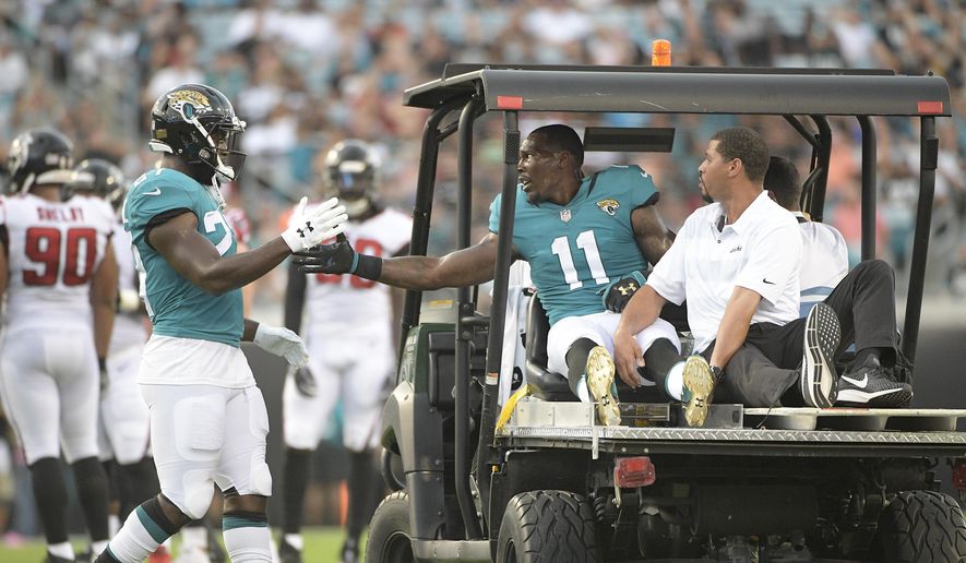 Jacksonville Jaguars running back Leonard Fournette, left, gives wide receiver Marqise Lee (11) a handshake after Lee was injured during the first half of an NFL preseason football game against the Atlanta Falcons, Saturday, Aug. 25, 2018, in Jacksonville, Fla. (AP Photo/Phelan M. Ebenhack) **FILE**