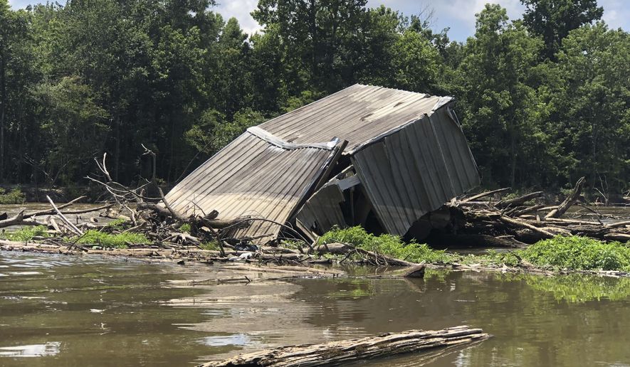 This June 6, 2018, photo provided by state Rep. Malinda B. White shows a logjam on the Pearl River, south of Bogalusa, La. The government will soon begin clearing a logjam that keeps threatened fish from swimming up the Pearl River and has also gathered debris including refrigerators, televisions, boats and even a houseboat. (Malinda B. White via AP)