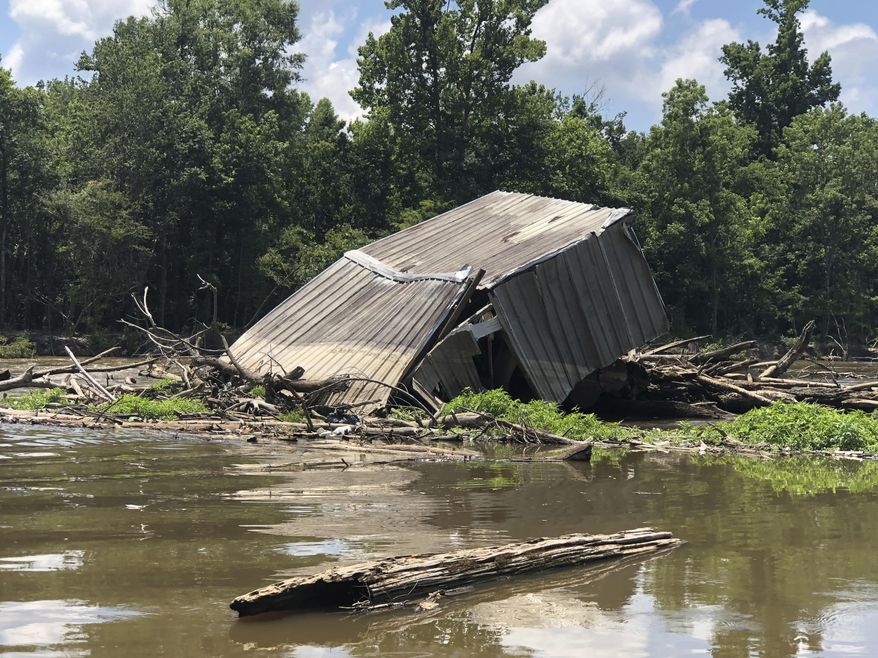This June 6, 2018, photo provided by state Rep. Malinda B. White shows a logjam on the Pearl River, south of Bogalusa, La. The government will soon begin clearing a logjam that keeps threatened fish from swimming up the Pearl River and has also gathered debris including refrigerators, televisions, boats and even a houseboat. (Malinda B. White via AP)