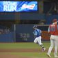 Toronto Blue Jays&#39; Kendrys Morales, left, rounds the bases after hitting a two-run home run off Philadelphia Phillies pitcher Nick Pivetta (43) during the fourth inning of a baseball game Saturday, Aug. 25, 2018, in Toronto. (Jon Blacker/The Canadian Press via AP)