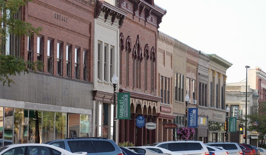 In this Aug. 13, 2018, photo provided by MinnPost, cars line a street in downtown Faribault, Minn. Faribault has seen an influx of Somali immigrants in the last three decades. The demographic change initiated by that shift didn't come without consequence, and it is only now, some residents say _ after years of grappling with cultural and racial issues, and overwhelmed schools and social service programs _ that those tensions are starting to fade away, as more and more native-born residents come to terms with the fact that Somali refugees are putting down permanent roots in Faribault. (Ibrahim Hirsi/MinnPost via AP)