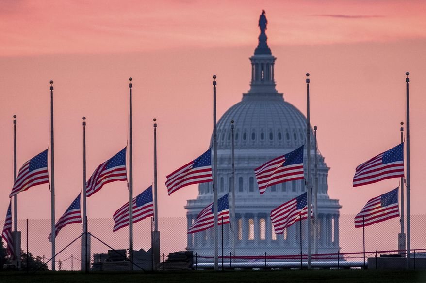 Flags flying a half-staff in honor of Sen. John McCain, R-Ariz., frame the U.S. Capital at daybreak in Washington, Sunday, Aug. 26, 2018. McCain, 81, died at his ranch in Arizona after a yearlong battle with brain cancer. (AP Photo/J. David Ake)