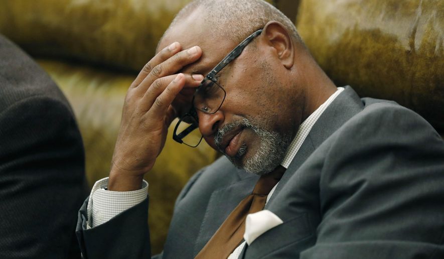 Rep. Robert Johnson III, D-Natchez, rubs his head as discussion over a lottery bill continues in House chambers at the Capitol in Jackson, Miss., Monday, Aug. 27, 2018. The Mississippi House killed a bill that would create a state lottery, voting 60-54 against it. The lottery was an attempt to put about $200 million a year into highways and bridges. However, the bill was held for the possibility of more debate. That means supporters could try to revive it. (AP Photo/Rogelio V. Solis)