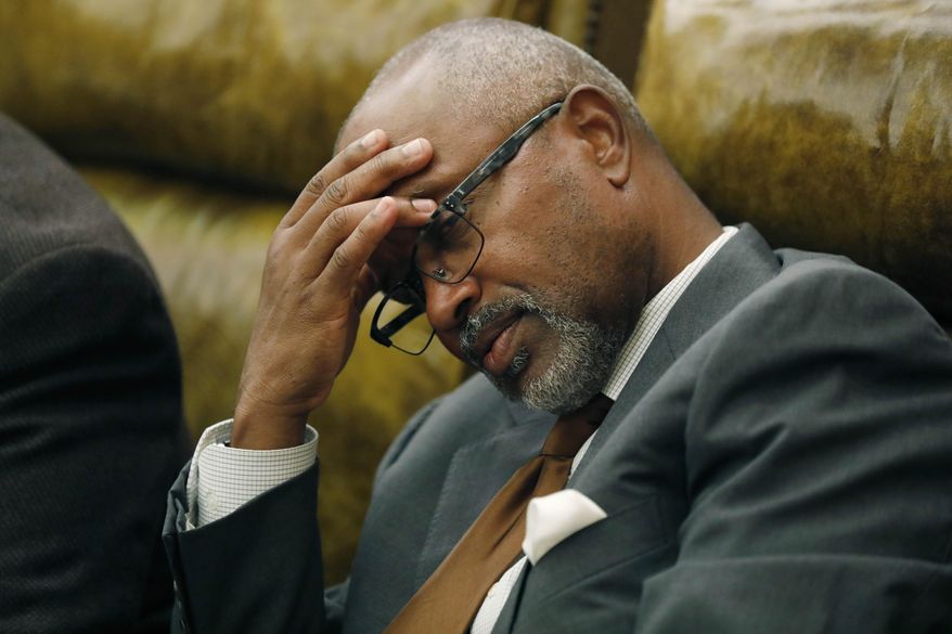 Rep. Robert Johnson III, D-Natchez, rubs his head as discussion over a lottery bill continues in House chambers at the Capitol in Jackson, Miss., Monday, Aug. 27, 2018. The Mississippi House killed a bill that would create a state lottery, voting 60-54 against it. The lottery was an attempt to put about $200 million a year into highways and bridges. However, the bill was held for the possibility of more debate. That means supporters could try to revive it. (AP Photo/Rogelio V. Solis)