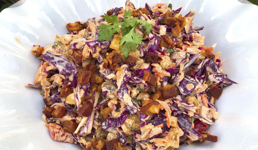 This Aug. 24, 2018, photo shows Confetti Coleslaw from a recipe by Elizabeth Karmel in Amagansett, N.Y. It is vibrant and pleasing to the eye, chock full of veggies, and the dressing is spiced with cumin, paprika and cilantro which are perfect companions to ribs with a spice-rub that includes some of the same flavors. (Elizabeth Karmel via AP)