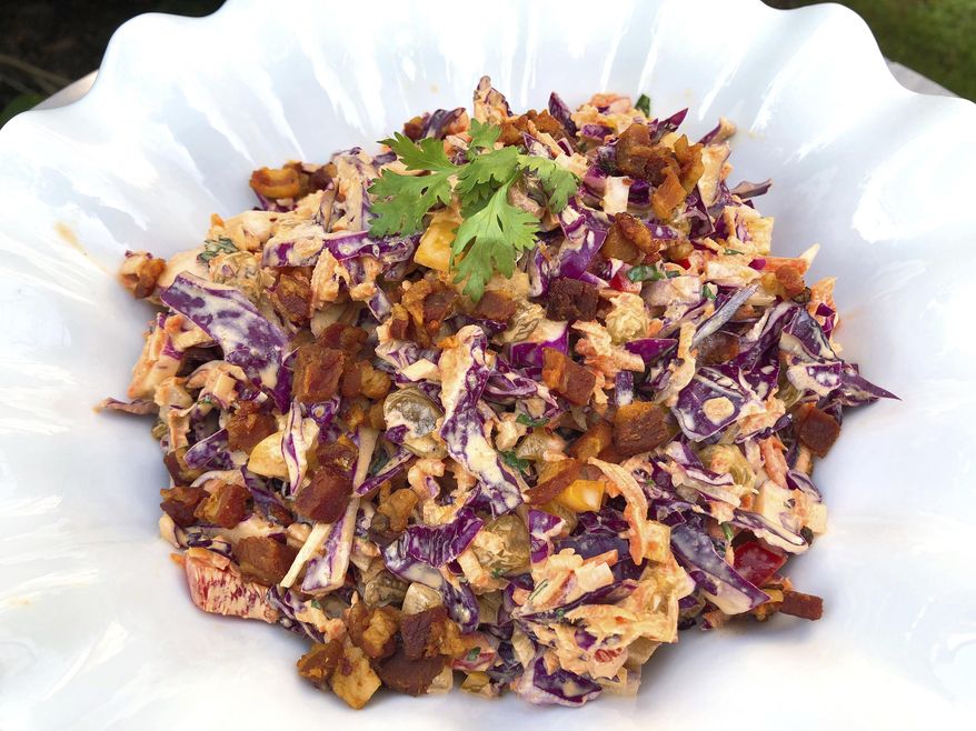 This Aug. 24, 2018, photo shows Confetti Coleslaw from a recipe by Elizabeth Karmel in Amagansett, N.Y. It is vibrant and pleasing to the eye, chock full of veggies, and the dressing is spiced with cumin, paprika and cilantro which are perfect companions to ribs with a spice-rub that includes some of the same flavors. (Elizabeth Karmel via AP)