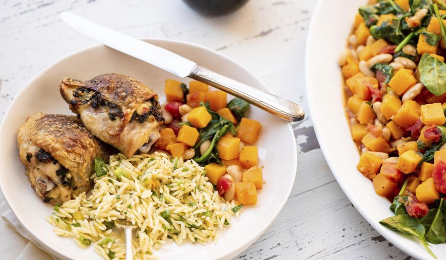 This May 2018 photo shows spinach- and feta-stuffed chicken thighs in New York. This dish is from a recipe by Katie Workman. (Cheyenne Cohen via AP)
