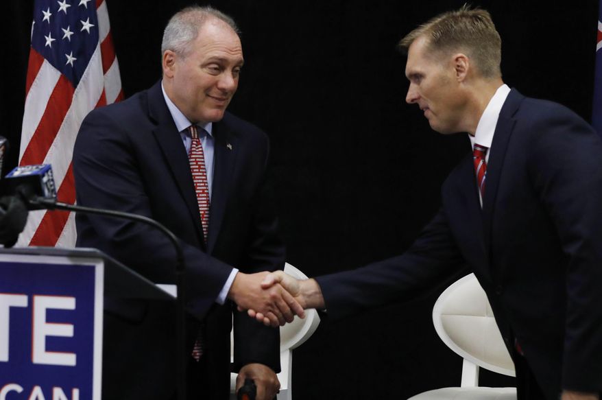 House Majority Whip U.S. Rep. Steve Scalise, R-La., left, shakes hands with Mike Guest, Republican nominee for the state's Third Congressional District race, during a press availability in Jackson, Miss., Monday, Aug. 27, 2018. Scalise was in Mississippi to headline a luncheon to benefit the Mississippi Republican Party's United Republican Fund.(AP Photo/Rogelio V. Solis)