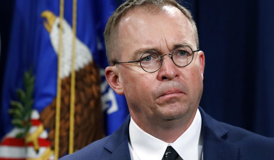 In this July 11, 2018, photo, Mick Mulvaney, acting director of the Consumer Financial Protection Bureau (CFPB), and Director of the Office of Management, listens during a news conference at the Department of Justice in Washington. (Associated Press) **FILE**