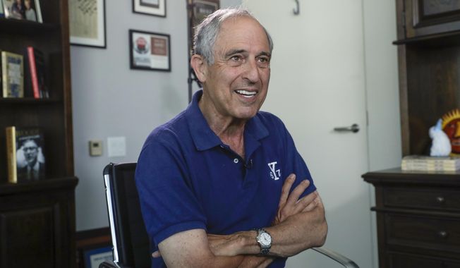 FILE - In this May 3, 2018, file photo, attorney Lanny Davis speaks during an interview with The Associated Press in his K Street office in Washington. Cohen’s lawyer is walking back his assertions that his client could tell a special prosecutor that Trump had prior knowledge of a meeting with a Russian lawyer to get damaging information on Hillary Clinton. Davis said Monday, Aug. 27, he “should been much clearer that I could not confirm the story.” (AP Photo/J. Scott Applewhite, File)