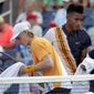 Denis Shapovalov, left, of Canada, passes in front of Felix Auger-Aliassime, also of Canada, during their first-round match at the U.S. Open tennis tournament, Monday, Aug. 27, 2018, in New York. (AP Photo/Julio Cortez)