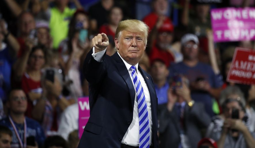 President Donald Trump points to supporters after speaking during a rally Tuesday, Aug. 21, 2018, in Charleston, W.Va. (AP Photo/Alex Brandon)