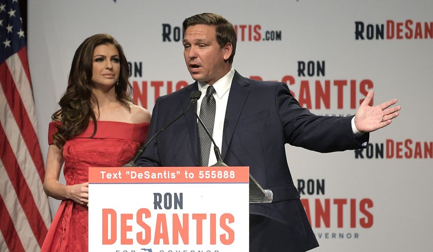 Florida Republican gubernatorial candidate Ron DeSantis, right, speaks to supporters with his wife, Casey, at an election party after winning the Republican primary, Tuesday, Aug. 28, 2018, in Orlando, Fla. (AP Photo/Phelan M. Ebenhack)