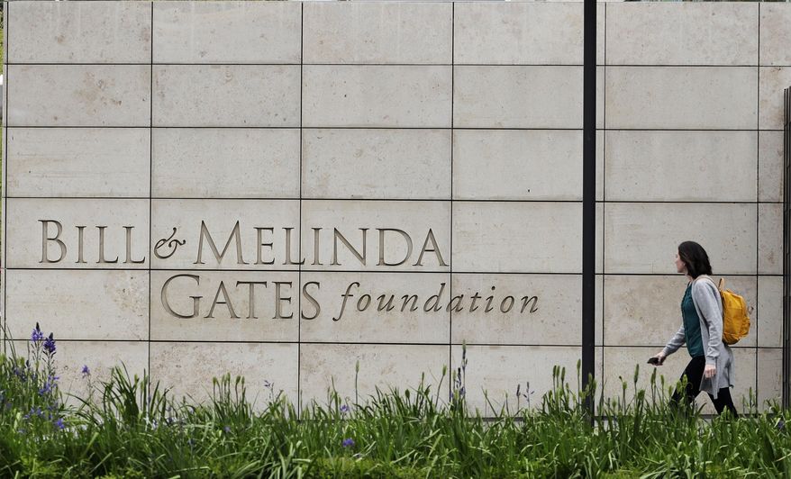 In this April 27, 2018, file photo, a person walks by the headquarters of the Bill and Melinda Gates Foundation in Seattle. (AP Photo/Ted S. Warren, File)