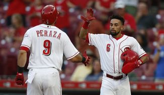 Cincinnati Reds&#39; Jose Peraza (9) is congratulated on a two-run home run off Milwaukee Brewers starting pitcher Junior Guerra by Billy Hamilton (6) during the first inning of a baseball game, Tuesday, Aug. 28, 2018, in Cincinnati. (AP Photo/Gary Landers)