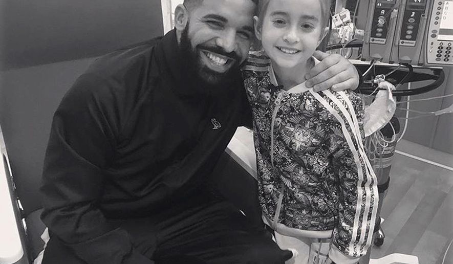 This Monday, Aug, 20, 2018 photo provided by the rapper Drake shows him posing with Sofia Sanchez, at Lurie Children's Hospital in Chicago. Drake surprised her after she recorded a video of herself dancing to the rapper's "In My Feelings" and invited him to her birthday party. Sanchez is awaiting a heart transplant. (OVO/Drake via AP)
