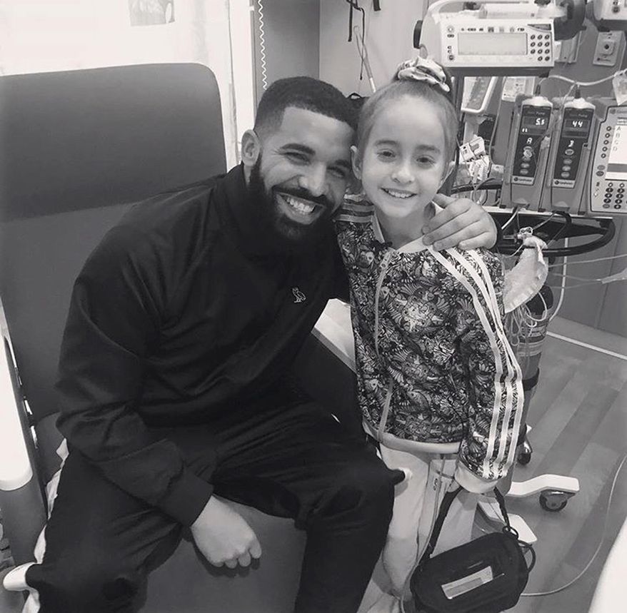This Monday, Aug, 20, 2018 photo provided by the rapper Drake shows him posing with Sofia Sanchez, at Lurie Children's Hospital in Chicago. Drake surprised her after she recorded a video of herself dancing to the rapper's "In My Feelings" and invited him to her birthday party. Sanchez is awaiting a heart transplant. (OVO/Drake via AP)