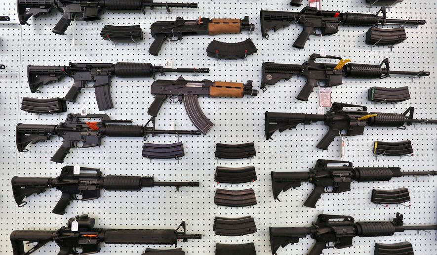 FILE - In this July 20, 2014 file photo, guns are displayed for sale by an arms seller east of Colorado Springs, Colo. The U.S. is among wealthy countries where suicides by gun outnumber gun killings, according to a study of 1990-2016 data, released on Tuesday, Aug. 28, 2018. (AP Photo/Brennan Linsley, File)