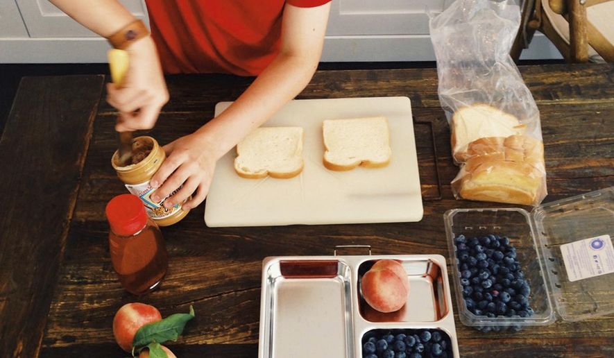 This 2015 photo provided by Katie Workman shows her son Charlie Freilich working in the kitchen at his home in New York. (Katie Workman via AP)
