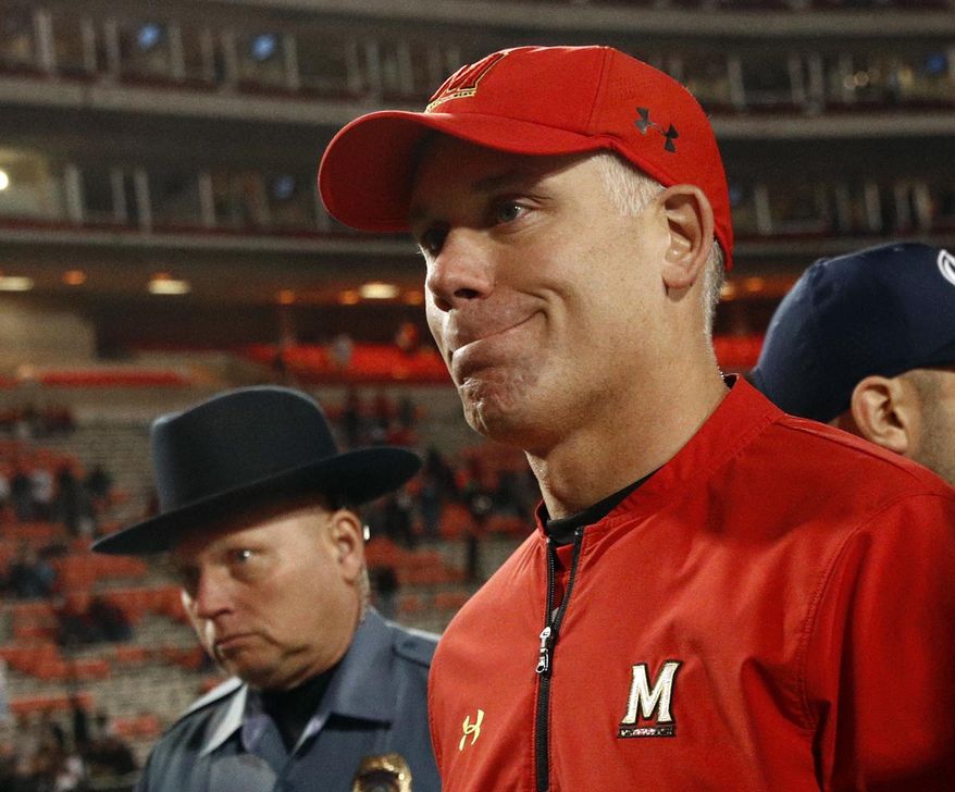 FILE - In this Nov. 25, 2017, file photo, Maryland head coach DJ Durkin walks off the field after an NCAA college football game against Penn State, in College Park, Md. As interim coach of the Maryland football team, Matt Canada is preparing the squad ready for Saturday’s opener against No. 23 Texas, fulfilling his duties as offensive coordinator and, most importantly, making sure to keep the players focused in a season dedicated to fallen teammate Jordan McNair. McNair, a sophomore offensive lineman, died on June 13, two weeks after collapsing during a team workout. Since that time, Maryland has launched two investigations _ one to unearth the circumstances surrounding McNair’s death, the other to address allegations of an abusive culture within the program. Head coach Durkin was placed on administrative leave on Aug. 11, leaving Canada in charge of a team with no shortage of distractions. (AP Photo/Patrick Semansky, File)