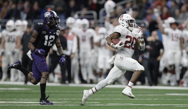 FILE - In this Dec. 28, 2017, file photo, Stanford running back Bryce Love (20) is pursued by TCU cornerback Jeff Gladney (12) as he runs for a touchdown during the second half of the Alamo Bowl NCAA college football game, in San Antonio. Love bucked popular opinion by sticking with the Cardinal rather than declaring early for the NFL draft.(AP Photo/Eric Gay, File)