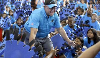 Carolina Panthers owner David Tepper greets students during a &amp;quot;kickoff rally&amp;quot; at Thomasboro Academy in Charlotte, N.C., Tuesday, Aug. 28, 2018. Tepper&#39;s charitable foundation along with several players groups and other partners will provide over 12,000 backpacks full of supplies to 17 elementary schools in Charlotte-Mecklenburg Schools, as well as an additional school in Kannapolis City Schools. (AP Photo/Chuck Burton)