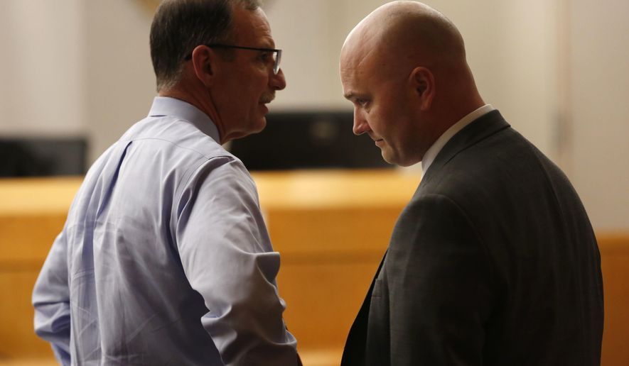 Defendant Roy Oliver, right, a fired Balch Springs police officer charged with the murder of 15-year-old Jordan Edwards, and his defense attorney Bob Gill speak after seeing a question from the jury indicating they can't reach a unanimous verdict during a trial of Oliver at the Frank Crowley Courts Building in Dallas on Tuesday, Aug. 28, 2018. Oliver was convicted of murder on Tuesday for fatally shooting an unarmed black teenager when he fired into a car full of teenagers leaving a house party in suburban Dallas. (Rose Baca/The Dallas Morning News via AP, Pool)
