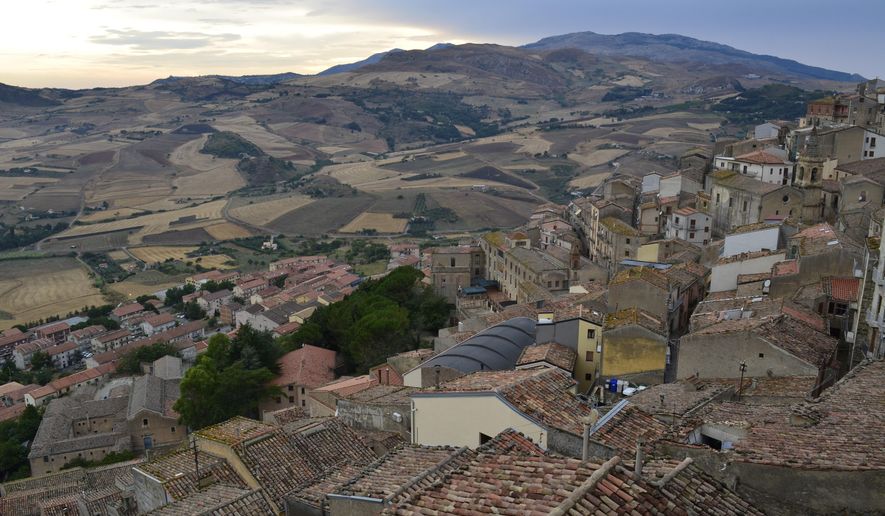 This Aug. 4, 2018 shows a view of Gangi, a medieval town in the Madonie Mountains of northern Sicily. The Madonie are a world apart from Sicily's packed summertime beaches and busy coastlines. This wild region of Sicily is known for its towns atop hills and mountains, its delicious food, ornate churches and friendly people. (Cain Burdeau via AP)