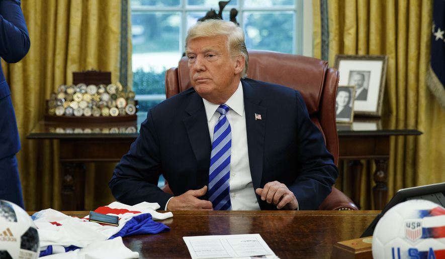 President Donald Trump listens to a question during a meeting with FIFA president Gianni Infantino and United States Soccer Federation president Carlos Cordeiro in the Oval Office of the White House, Tuesday, Aug. 28, 2018, in Washington. (AP Photo/Evan Vucci)