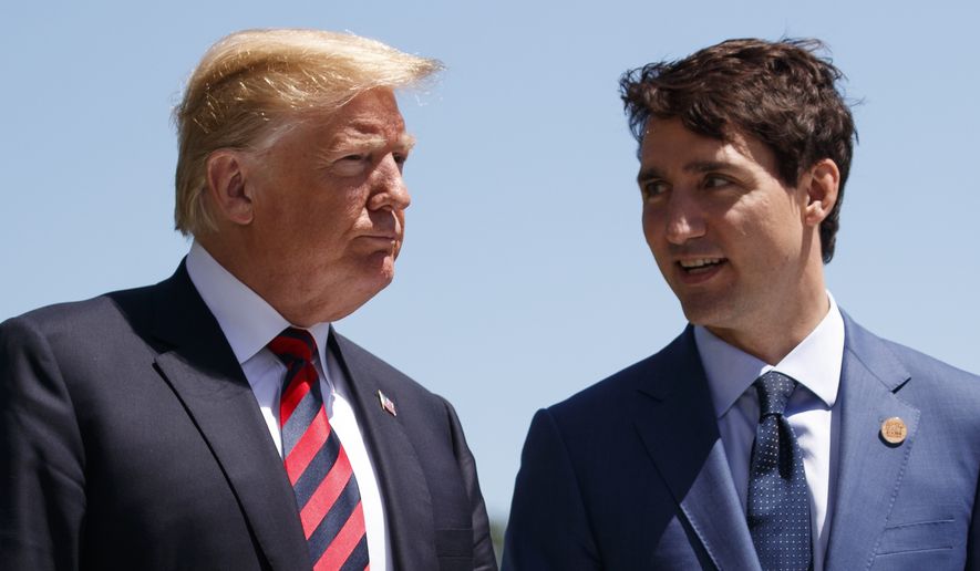 In this June 8, 2018, file photo, President Donald Trump talks with Canadian Prime Minister Justin Trudeau during a G-7 Summit welcome ceremony in Charlevoix, Canada. (AP Photo/Evan Vucci, File)