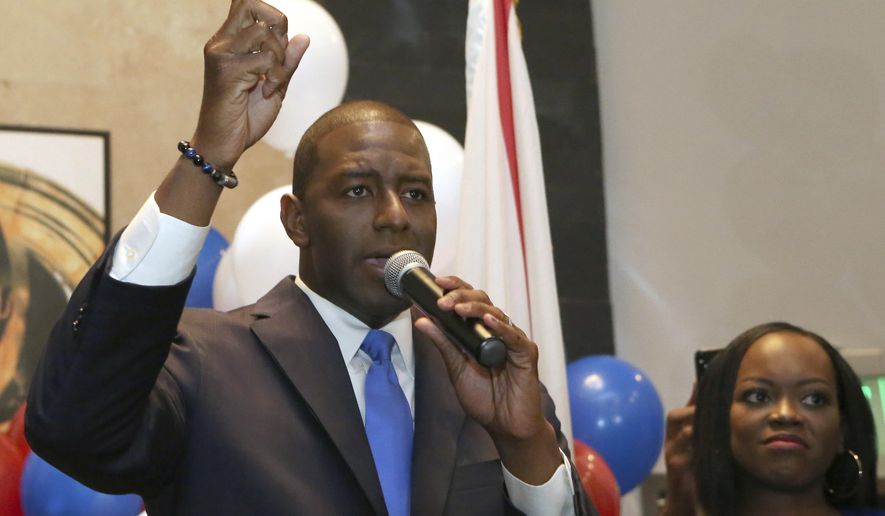 Andrew Gillum with his wife, R. Jai Gillum at his side addresses his supporters after winning the Democrat primary for governor on Tuesday, Aug. 28, 2018, in Tallahassee, Fla. (AP Photo/Steve Cannon)