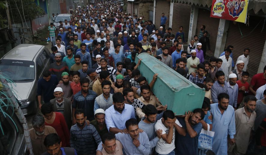 Villagers carry the body of slain policeman Adil Ahmad during his funeral at Zaura village, about 62 kilometers south of Srinagar, Indian controlled Kashmir, Wednesday, Aug. 29, 2018. Rebels fighting against Indian rule ambushed a group of police officers and killed four of them, including Ahmad, on Wednesday in the disputed Himalayan region of Kashmir, police said. (AP Photo/Mukhtar Khan)