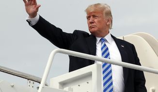 hoto, President Donald Trump waves as he boards Air Force One at Andrews Air Force Base, Md. (AP Photo/Alex Brandon, File)