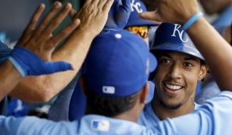 Kansas City Royals&#39; Adalberto Mondesi celebrates with Salvador Perez in the dugout after hitting a two-run home run during the second inning of a baseball game against the Detroit Tigers Wednesday, Aug. 29, 2018, in Kansas City, Mo. (AP Photo/Charlie Riedel)