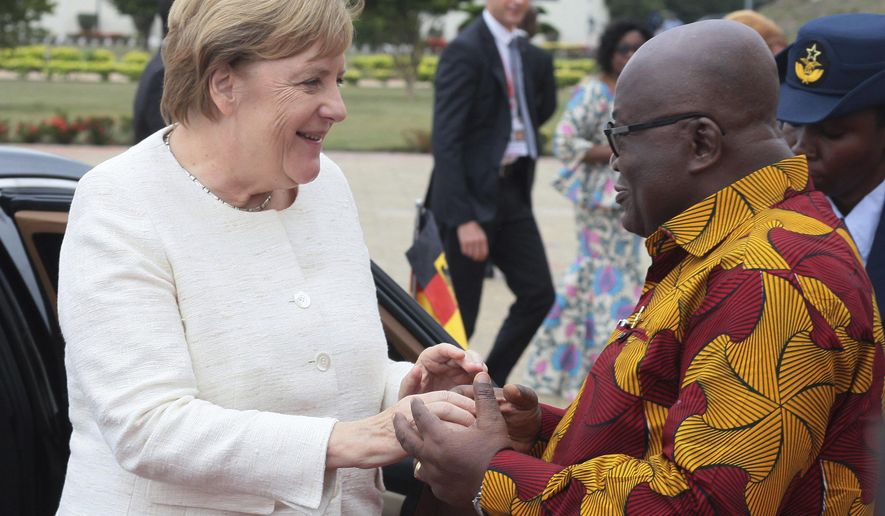 German Chancellor Angela Merkel, left, is welcomed by Ghana's President, Nana Akufo-Addo, right, at the Presidential palace in Accra, Ghana, Thursday, Aug 30, 2018. Merkel has arrived in Ghana during a three-nation West Africa visit aimed at boosting investment in a region that is a major source of migrants heading towards Europe. (AP Photo)