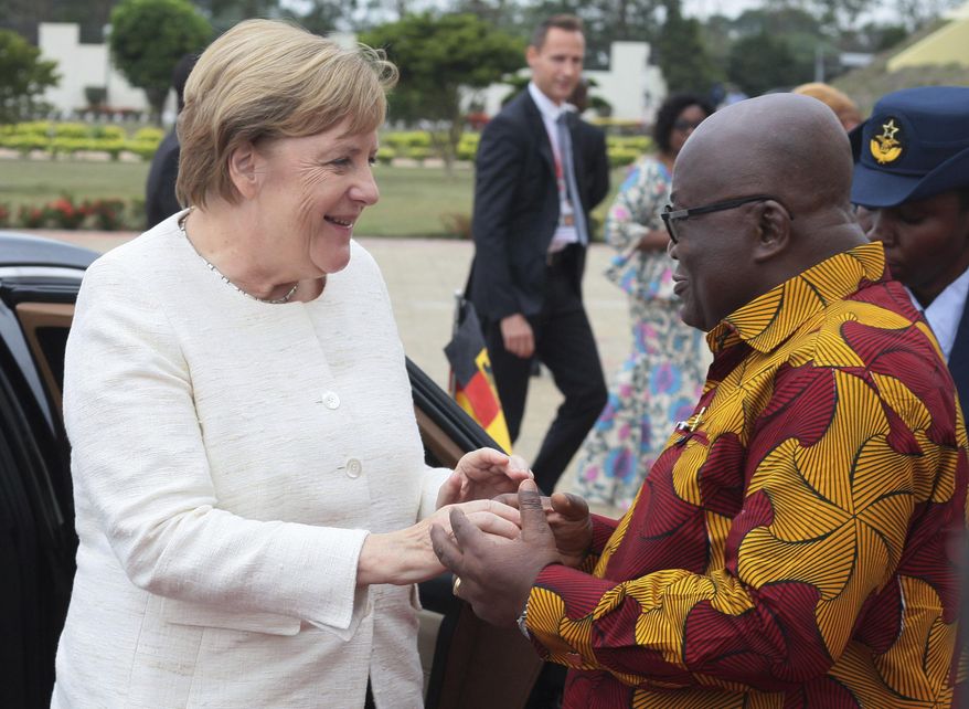 German Chancellor Angela Merkel, left, is welcomed by Ghana's President, Nana Akufo-Addo, right, at the Presidential palace in Accra, Ghana, Thursday, Aug 30, 2018. Merkel has arrived in Ghana during a three-nation West Africa visit aimed at boosting investment in a region that is a major source of migrants heading towards Europe. (AP Photo)