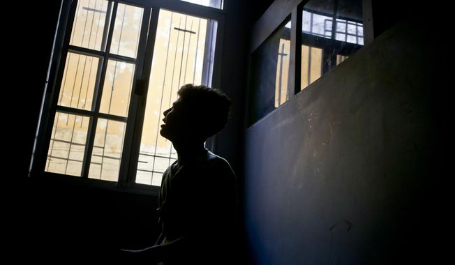 In this July 27, 2018 photo, 15-year-old Jus, who did not want to give his last name for security reasons, works on composing songs at the shelter where he lives that takes in deported migrant youths who cannot return home due to high violence in their communities, where they risk getting forced into gangs, in Tegucigalpa, Honduras. Jus was deported from Guatemala as he tried to make his way to the U.S. after his father was murdered by a gang in their home town. (AP Photo/Esteban Felix)
