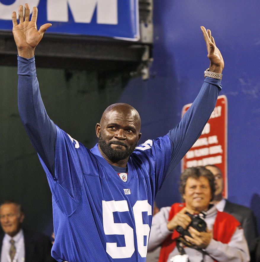 Lawrence Taylor, New York Giants (1981-1993) Former New York Giants linebacker Lawrence Taylor reacts to the crowd during a pre-game ceremony before an NFL football game between the Arizona Cardinals and the New York Giants  Sunday, Oct. 25, 2009, in East Rutherford, N.J.  (AP Photo/Mel Evans)