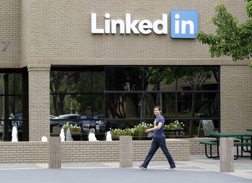 In this May 8, 2014, file photo, a man walks past the LinkedIn headquarters in Mountain View, Calif. LinkedIn reports financial results Thursday, Aug. 4, 2016. (AP Photo/Marcio Jose Sanchez, File)