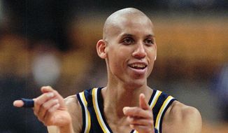 Indiana Pacers Reggie Miller taunts some front-row Boston Celtics fans who had been jeering him all game moments after he nailed a 3-point jump shot to win against the Celtics, 122-119, in overtime Monday night, Feb. 26, 1996, in Boston. Miller led the Pacers with 39 points. (AP Photo/Elise Amendola) ** FILE **