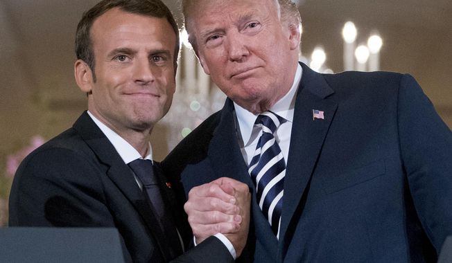 In this photo from Tuesday, April 24, 2018 , US President Donald Trump and French President Emmanuel Macron embrace at the conclusion of a news conference in the East Room of the White House in Washington.  (AP Photo/Andrew Harnik, File) **FILE**