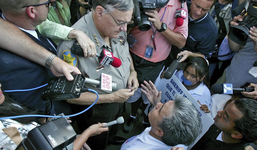 FILE - In this July 14, 2006, file photo, Elias Bermudez kneels before then-Sheriff Joe Arpaio at a protest over the lawman's immigration crackdowns in Phoenix. Bermudez, an advocate for immigrants in Arizona who also operated a tax preparation business has pleaded guilty to a federal charge after acknowledging he falsely added dependents to his clients' tax returns to maximize refundable credits. Bermudez pleaded guilty Friday, Aug. 31, 2018, to a charge of assisting in the preparation of false tax returns. (AP Photo/Matt York, File)