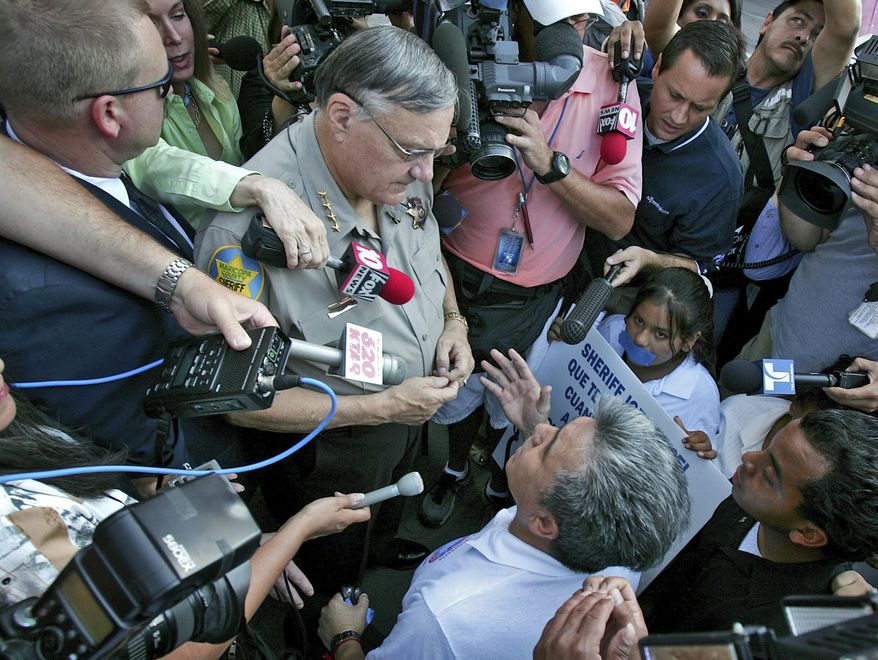 FILE - In this July 14, 2006, file photo, Elias Bermudez kneels before then-Sheriff Joe Arpaio at a protest over the lawman's immigration crackdowns in Phoenix. Bermudez, an advocate for immigrants in Arizona who also operated a tax preparation business has pleaded guilty to a federal charge after acknowledging he falsely added dependents to his clients' tax returns to maximize refundable credits. Bermudez pleaded guilty Friday, Aug. 31, 2018, to a charge of assisting in the preparation of false tax returns. (AP Photo/Matt York, File)