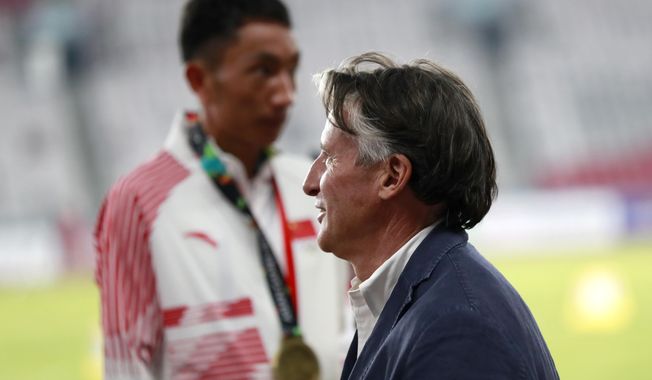 In this Saturday Aug. 25, 2018 photo, President of the International Association of Athletics Federations (IAAF) Sebastian Coe waits at the medal ceremony for the men&#x27;s marathon during the athletics competition at the 18th Asian Games in Jakarta, Indonesia. Coe says China and Japan are the two most improved countries in athletics over the last six or seven years.(AP Photo/Bernat Armangue)