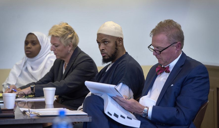 In this Aug. 29, 2018, file photo, Jany Leveille, from left, with her attorney Kelly Golightley, and Siraj Ibn Wahhaj with attorney Tom Clark listen to the prosecutor during a hearing on a motion to dismiss in the Taos County Courthouse. Federal prosecutors say the FBI has arrested five former residents, including Leveille and Wahhaj, of a ramshackle compound in northern New Mexico on firearms and conspiracy charges as local prosecutors dropped charges in the death of a 3-year-old boy at the property. Taos County District Attorney Donald Gallegos said Friday, Aug. 31, his office will now seek grand jury indictments involving the death. (Eddie Moore/The Albuquerque Journal via AP, Pool, File)