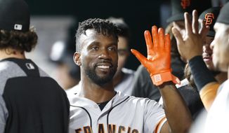 FILE - In this Aug. 18, 2018, file photo, San Francisco Giants&#39; Andrew McCutchen, center, is congratulated in the dugout after scoring during the eighth inning of a baseball game against the Cincinnati Reds, in Cincinnati.The playoff-contending New York Yankees are close to completing a trade for San Francisco Giants outfielder Andrew McCutchen. A person familiar with the negotiations told The Associated Press on Thursday night, Aug. 30, 2018,  the Yankees would send infielder Abiatal Avelino and another minor leaguer to San Francisco for McCutchen. The person spoke on condition of anonymity because the deal wasn&#39;t finalized. (AP Photo/Gary Landers, File)